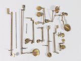 many different types of brass hardware on a white surface