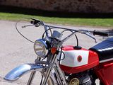 a red and white motorcycle parked on the side of the road