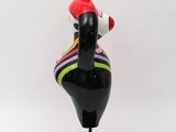 a black and red sculpture of a woman sitting on top of a black base