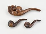 two pipe holders that have a cat on one of them