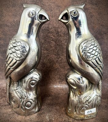pair of silver bird salt and pepper shakers on a brown background