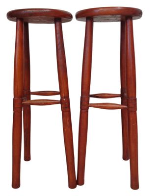 a pair of wooden stools sitting on top of each other
