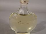 a small bottle of perfume sitting on a table