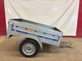 a silver trailer with a blue stripe on the side of it