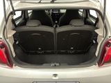 the back of a white car with two seats in the trunk