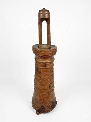 an old wooden bell with a wooden handle on a white background