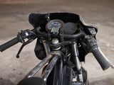 a close up of a motorcycle handlebars with a clock on it