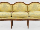 an image of a couch with a yellow and green upholstered cover