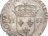 a close up of a coin with a crown on top of it