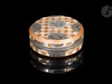 a round box with a checkered pattern on it