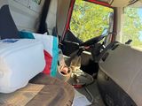 the interior of a van with a couch and a bed in it
