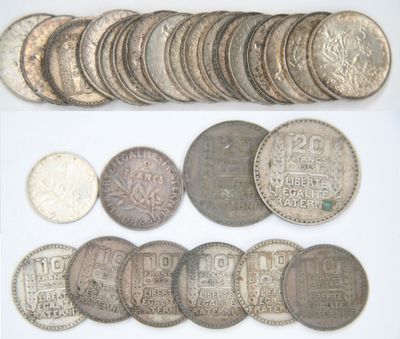 an assortment of silver and silver coins on a white surface