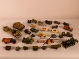 a lot of toy army vehicles on a white table