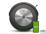 un gros plan d'un Roomba avec un téléphone portable à côté