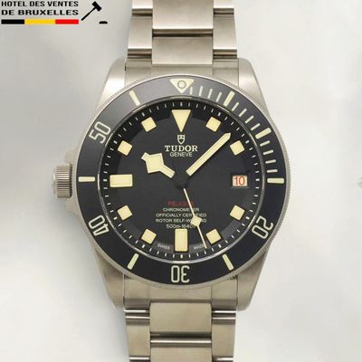the watch has a black dial and yellow numbers on the face