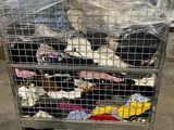 a cart full of clothes that is sitting in a warehouse