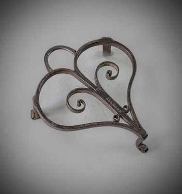 a metal hook with a heart shaped design on it