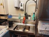 a kitchen with a sink, stove, and refrigerator in it