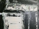 a black and white painting on the wall of a room