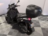 a motorcycle that is parked in a room with a checkered floor
