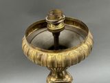 a gold plate with a candle on top of it