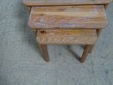 two wooden tables sitting on the floor next to each other