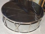 a black marble top coffee table on a marble floor