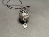 a silver ball with a key on it on a table