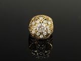 a gold and diamond ring on a black surface