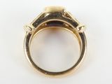 a close up of a gold ring with a diamond in the middle