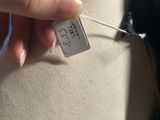 a person that is holding a tag on a mannequin