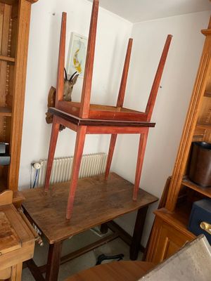 a desk with a chair and a shelf in a room
