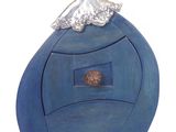 a sculpture of a woman sitting on top of a blue object