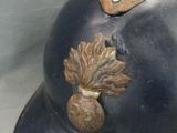a close up of a helmet with a leaf on it