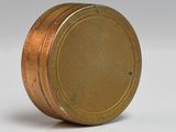 a close up of a small metal object on a white surface