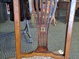 a wooden chair that is sitting in a room