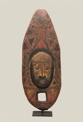 sculpture of a man ' s face on a stand with a geometric pattern