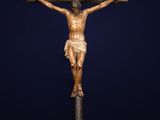 a statue of jesus on the cross on top of a pile of rocks