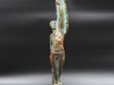 a close up of a statue of a person holding a surfboard