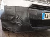 a car that has been painted black and has a number plate on it