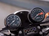 two gauges on the handlebars of a motorcycle