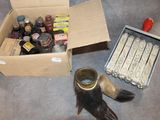 a box of assorted items on the floor next to a bird ' s foot