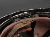a close up of a helmet with a leather strap