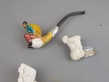 two pipe holders and a pipe holder on a table