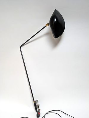 a black lamp that is on top of a table