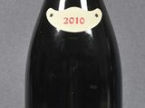 two bottles of wine sitting next to each other on a table