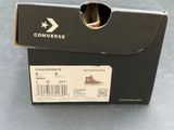 a box that has a pair of converse shoes in it