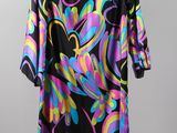 a black and multicolored dress hanging on a hanger