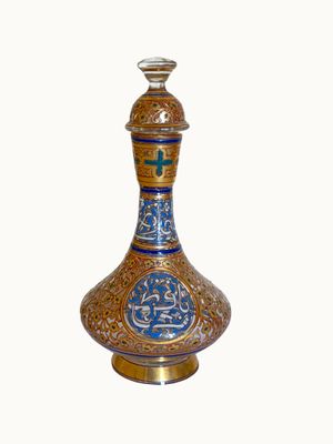 a blue and gold vase sitting on a white surface