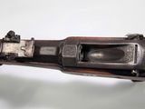 an old gun is being held up by a person ' s hand